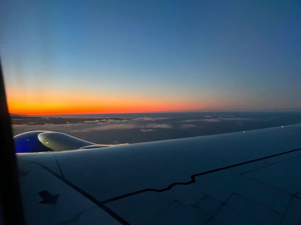 sunrise over airplane wing